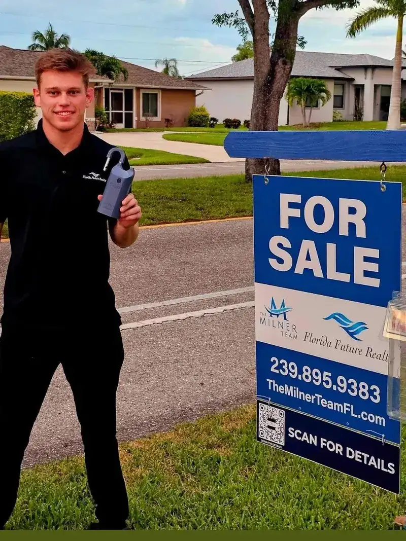 Brayden Milner at the team sign with the lockbox open after a sale