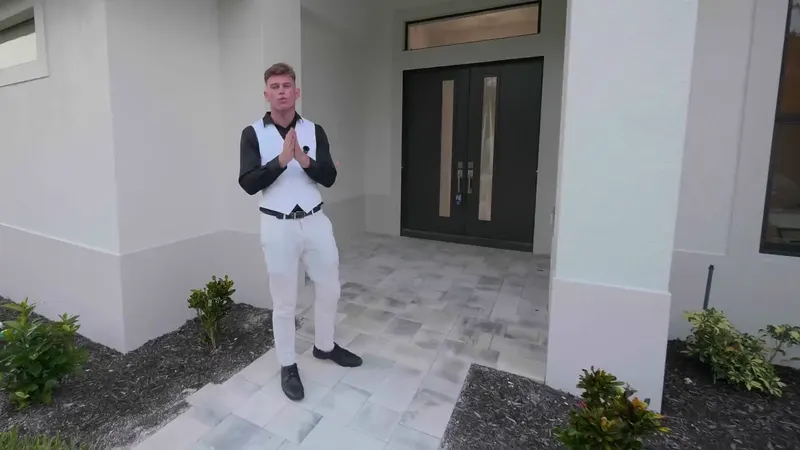 Brayden Milner of The Milner Team at the front doors of a new Southwest Florida home, the opening frame of our home-tour film