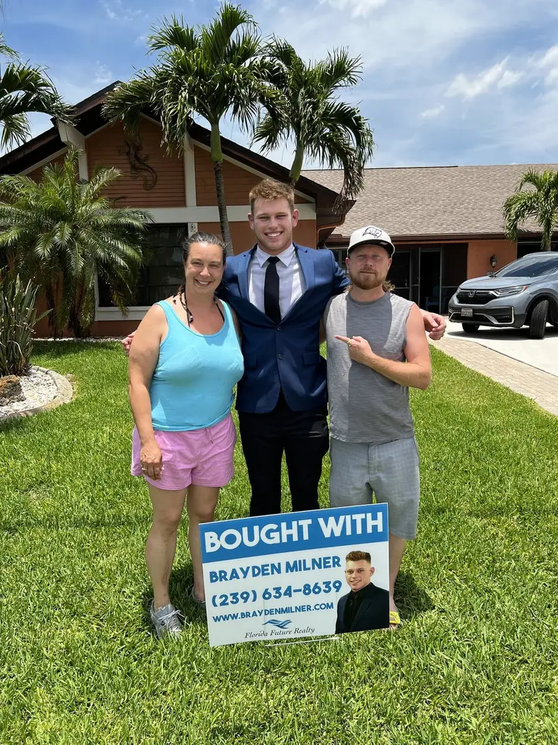 Real Cape Coral buyers in front of their new home with a &lsquo;Bought With Brayden Milner&rsquo; yard sign
