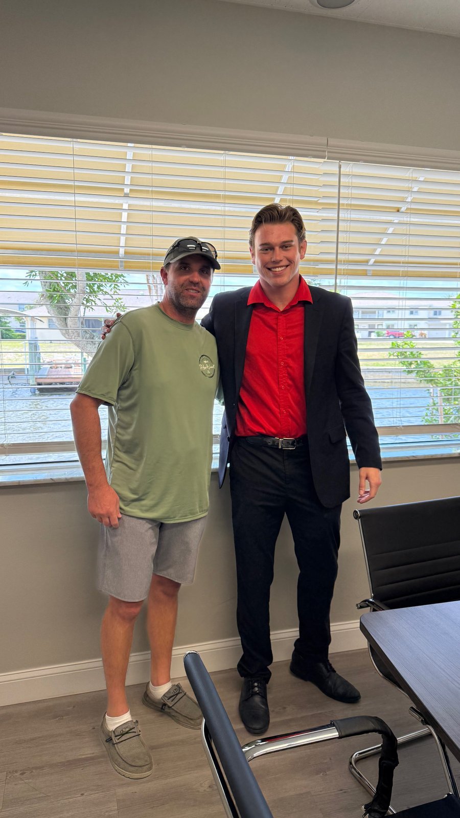 A buyer shaking hands with Brayden Milner after closing