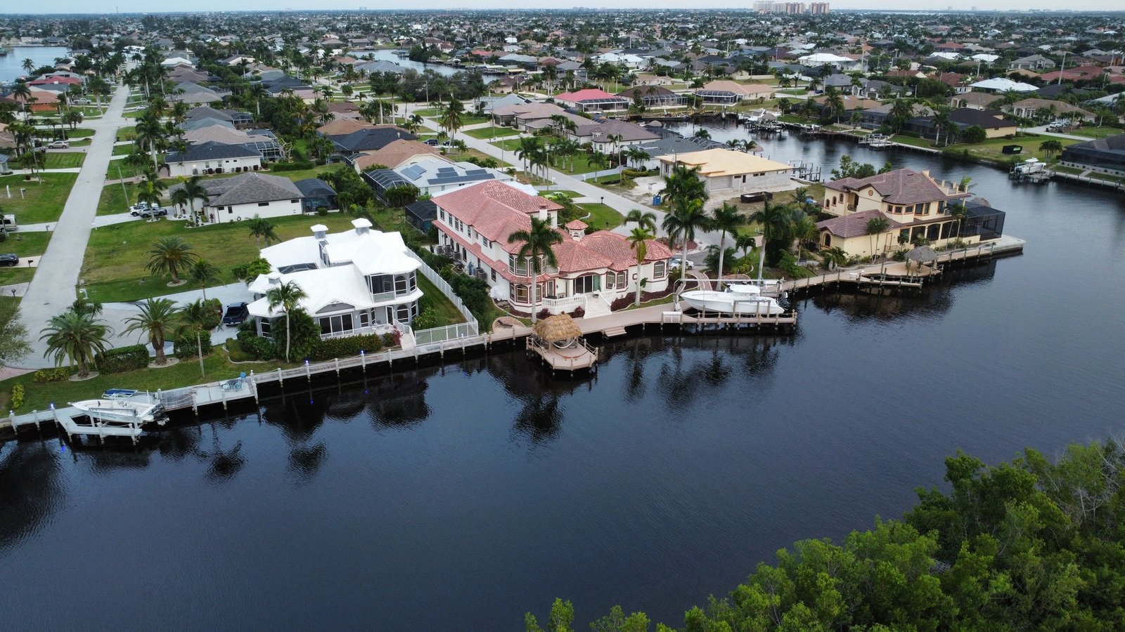 Aerial view of a large canal-front home in Cape Coral