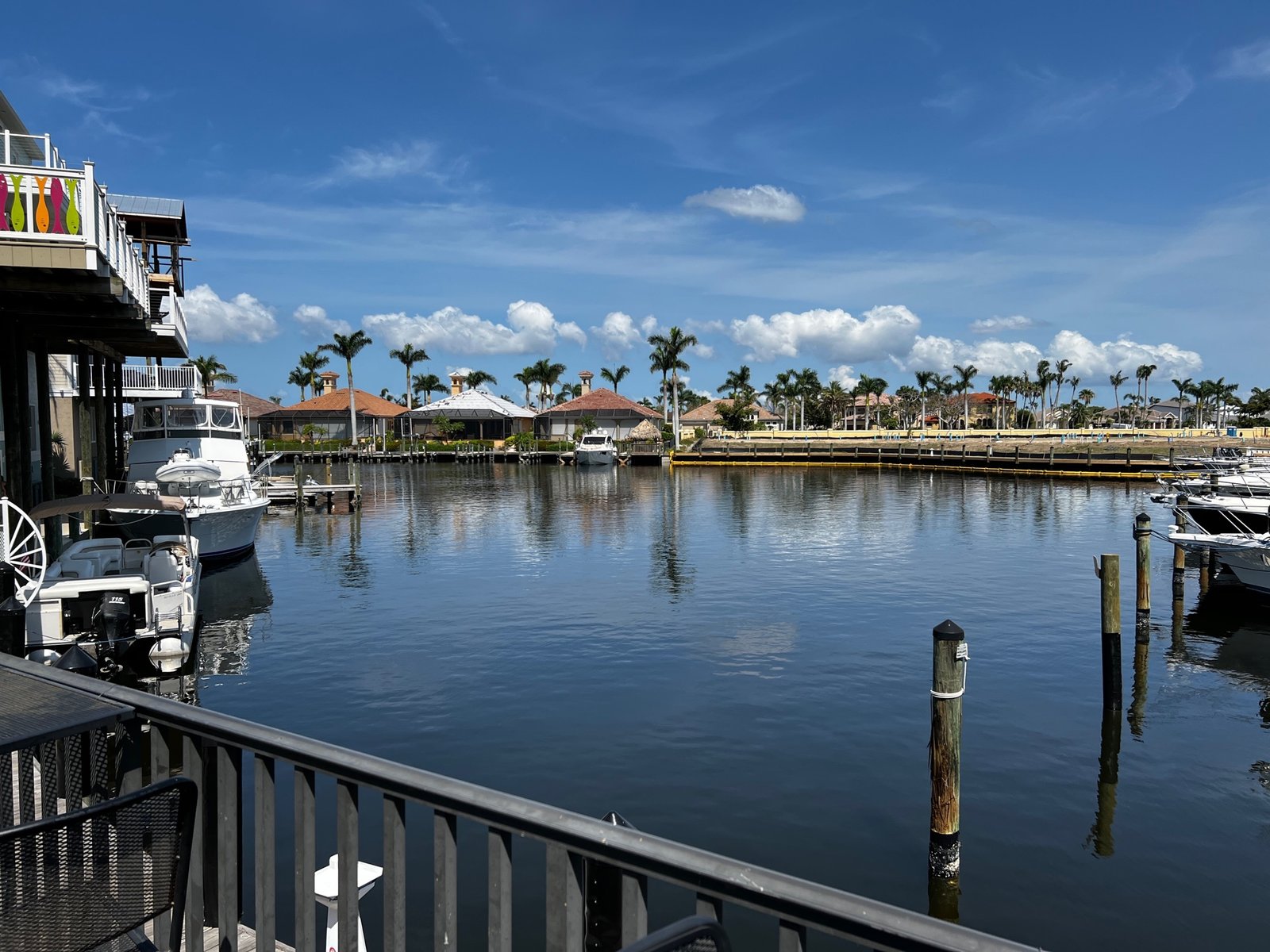 A Southwest Florida marina and canal neighborhood under a clear blue sky