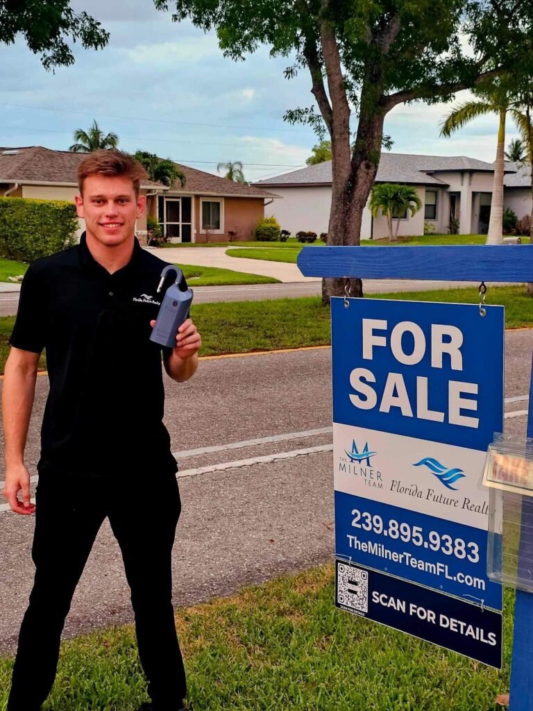 Brayden Milner in front of a Cape Coral home with a Milner Team For Sale sign